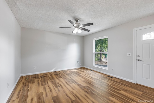 2452 S Kittredge Way, Aurora, CO 80013 - unfurnished room featuring wood finished floors, a textured ceiling, healthy amount of natural light, and a ceiling fan