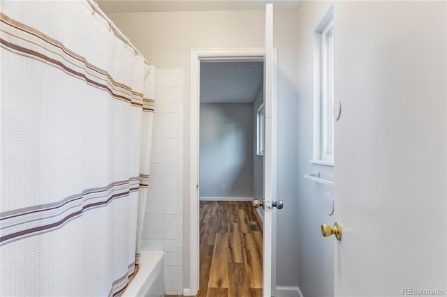 2452 S Kittredge Way, Aurora, CO 80013 - bathroom with wood finished floors and shower / tub combo with curtain