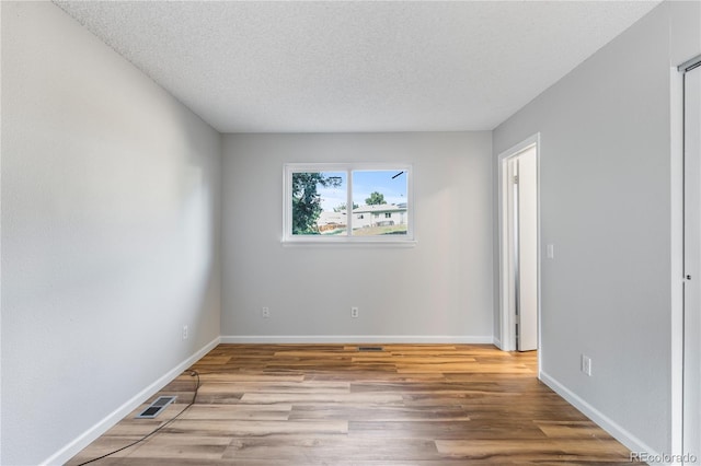 2452 S Kittredge Way, Aurora, CO 80013 - unfurnished room with wood finished floors and a textured ceiling