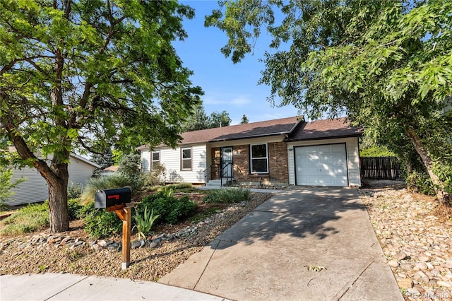 2452 S Kittredge Way, Aurora, CO 80013 - ranch-style house featuring driveway, brick siding, and an attached garage