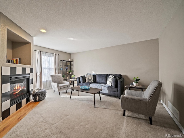 living room featuring carpet flooring and a textured ceiling