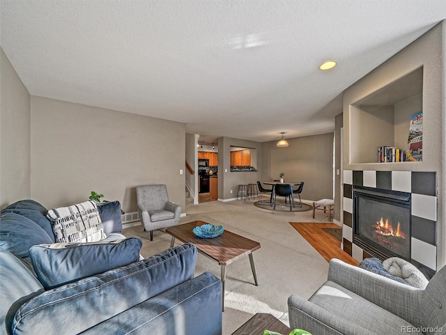 living room with a textured ceiling and carpet