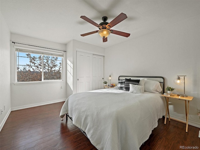 bedroom featuring dark wood-type flooring, a closet, and ceiling fan