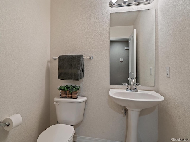 bathroom featuring sink and toilet