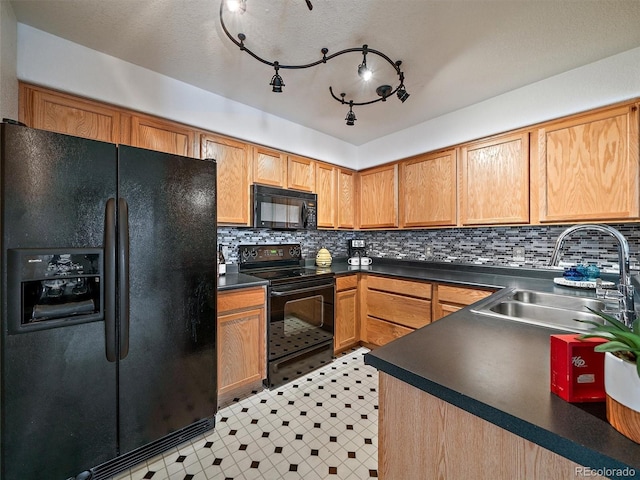 kitchen with backsplash, sink, and black appliances