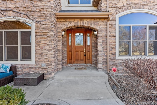 entrance to property featuring stone siding