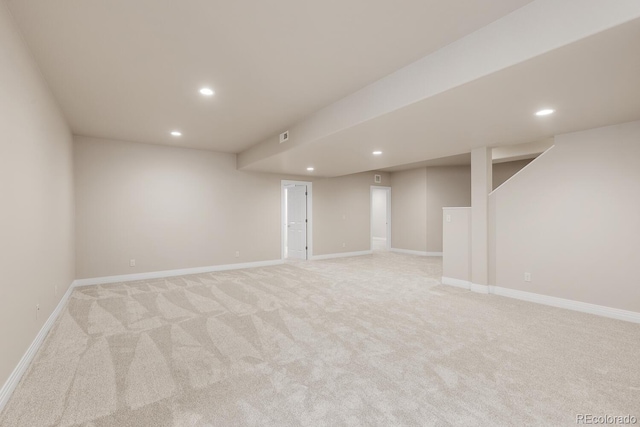 finished basement featuring light carpet, recessed lighting, and baseboards