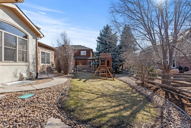 view of yard with a playground and fence