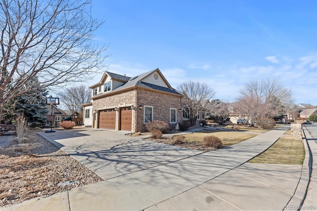 view of home's exterior featuring a garage, brick siding, and concrete driveway