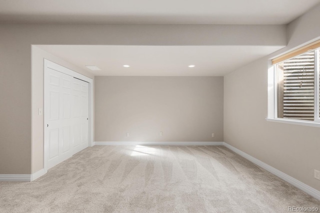 spare room with recessed lighting, carpet, and baseboards