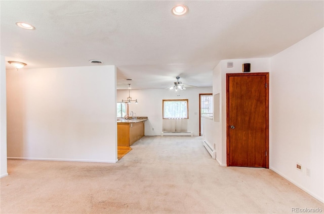 16291 E 7th Dr, Aurora, CO 80011 - unfurnished living room with a baseboard radiator, ceiling fan, a baseboard heating unit, light colored carpet, and recessed lighting