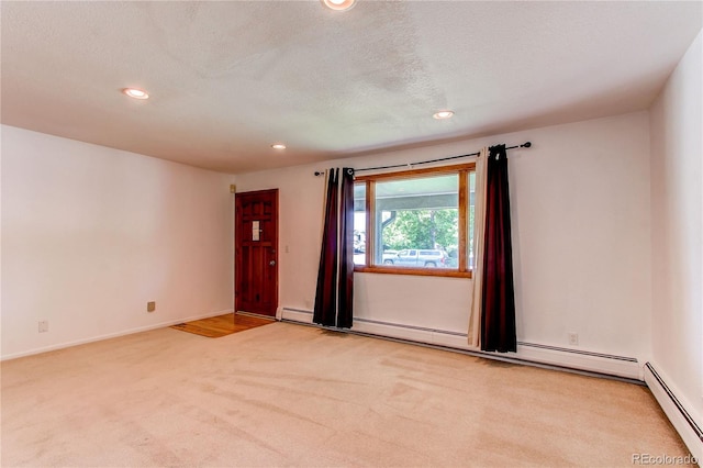 16291 E 7th Dr, Aurora, CO 80011 - empty room with a baseboard heating unit, light colored carpet, recessed lighting, and baseboards