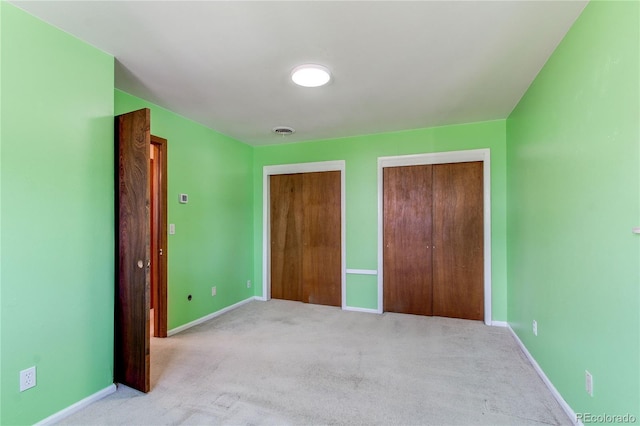 16291 E 7th Dr, Aurora, CO 80011 - unfurnished bedroom featuring two closets, carpet flooring, and baseboards