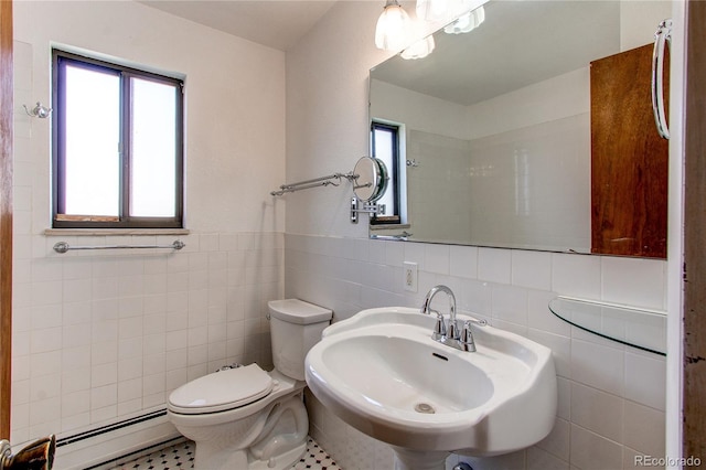 16291 E 7th Dr, Aurora, CO 80011 - bathroom with tile walls, a baseboard heating unit, toilet, and a sink