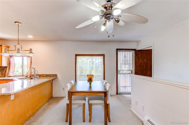 16291 E 7th Dr, Aurora, CO 80011 - dining space featuring healthy amount of natural light, light colored carpet, and baseboard heating