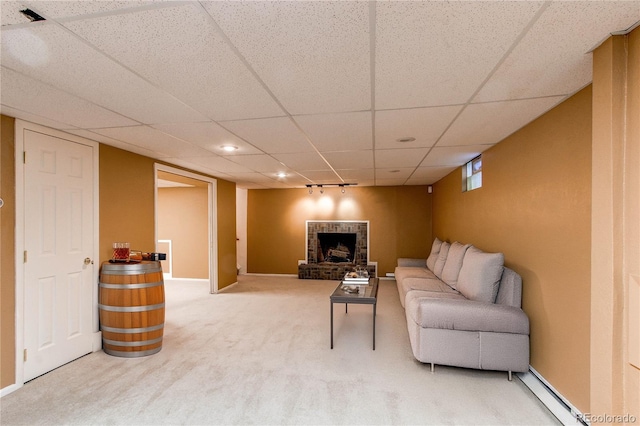 16291 E 7th Dr, Aurora, CO 80011 - living area featuring a baseboard radiator, carpet, a drop ceiling, and a fireplace