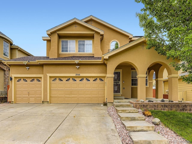 2544 S Fundy Cir, Aurora, CO 80013 - view of front of house featuring stucco siding, concrete driveway, a garage, and a porch