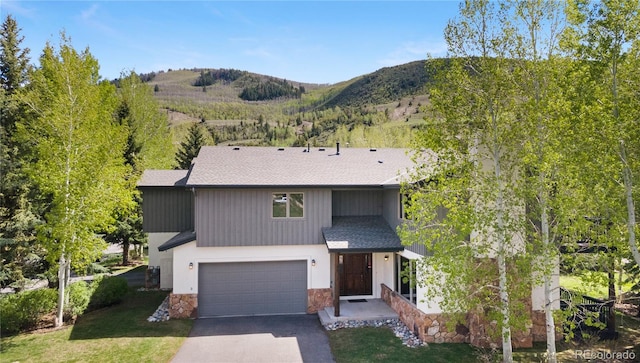 view of front facade with a garage and a mountain view