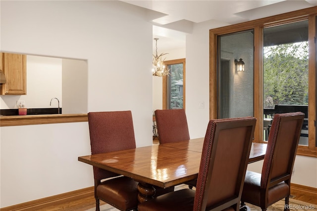 dining room featuring hardwood / wood-style flooring and an inviting chandelier