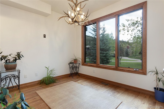 interior space featuring hardwood / wood-style floors and a notable chandelier