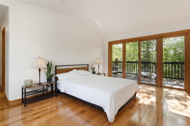 bedroom with lofted ceiling, multiple windows, access to exterior, and light hardwood / wood-style flooring