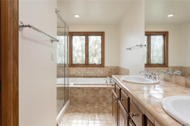 bathroom featuring tile patterned flooring, vanity, a healthy amount of sunlight, and shower with separate bathtub