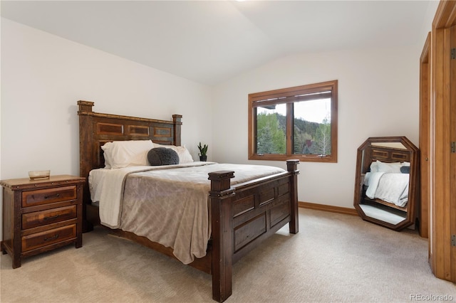 bedroom with light carpet and vaulted ceiling