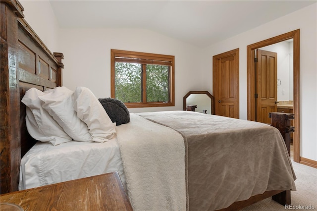 carpeted bedroom featuring lofted ceiling