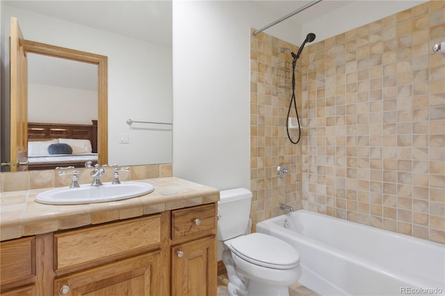 full bathroom featuring vanity, toilet, and tiled shower / bath combo