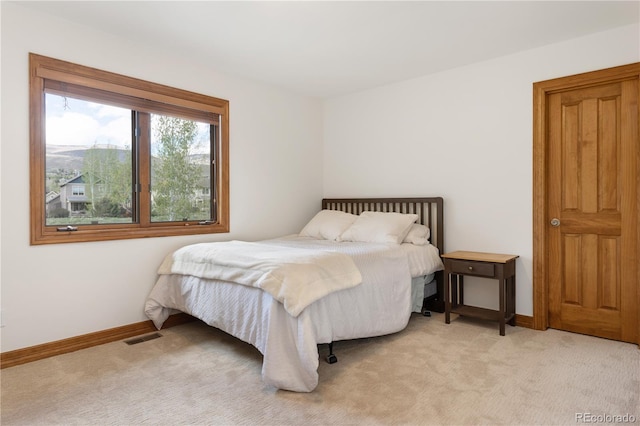 bedroom with light colored carpet