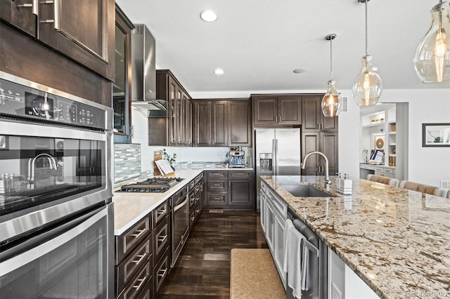 11046 Pastel Pt, Parker, CO 80134 - kitchen with appliances with stainless steel finishes, a sink, dark wood-type flooring, dark brown cabinets, and recessed lighting