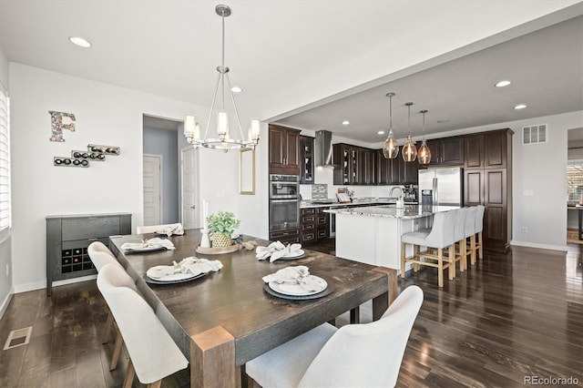 11046 Pastel Pt, Parker, CO 80134 - dining area featuring a chandelier, dark wood finished floors, baseboards, and recessed lighting