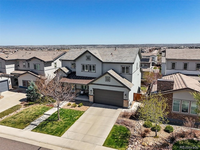 11046 Pastel Pt, Parker, CO 80134 - view of front of home with a residential view, concrete driveway, a garage, metal roof, and brick siding