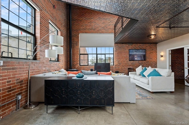 1515 N Ogden St Unit 7, Denver, CO 80218 - living room featuring plenty of natural light, finished concrete flooring, and brick wall