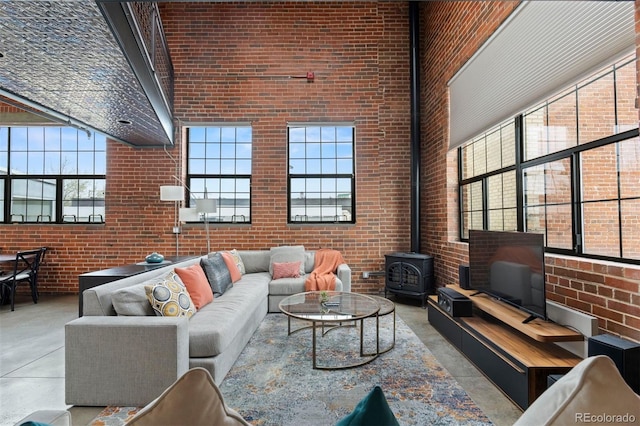1515 N Ogden St Unit 7, Denver, CO 80218 - living room with finished concrete flooring, a high ceiling, and brick wall