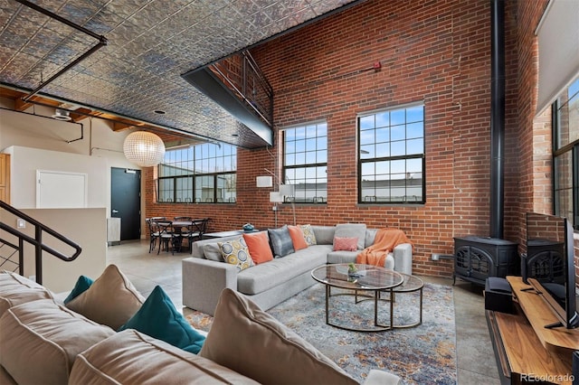 1515 N Ogden St Unit 7, Denver, CO 80218 - living area with a high ceiling, a wood stove, and brick wall