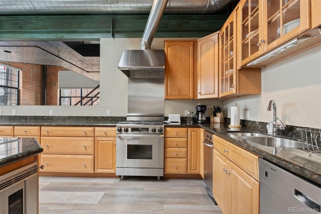 1515 N Ogden St Unit 7, Denver, CO 80218 - kitchen featuring dark stone countertops, wall chimney exhaust hood, a sink, light wood-style flooring, and appliances with stainless steel finishes
