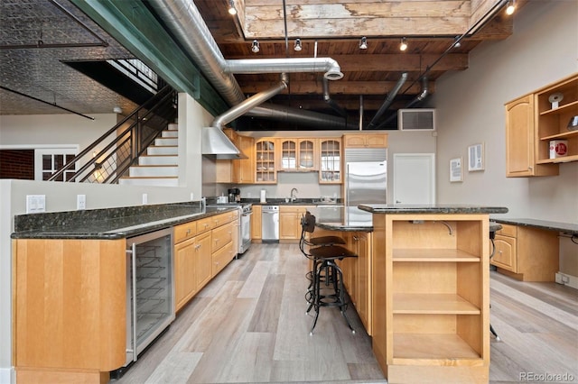 1515 N Ogden St Unit 7, Denver, CO 80218 - kitchen with light wood-style floors, appliances with stainless steel finishes, open shelves, track lighting, and wine cooler
