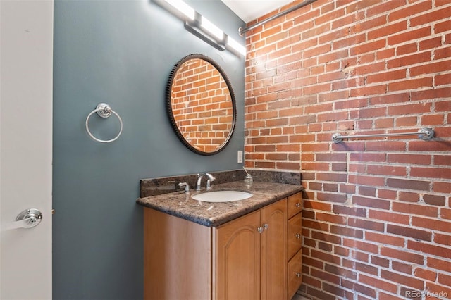 1515 N Ogden St Unit 7, Denver, CO 80218 - bathroom featuring vanity and brick wall