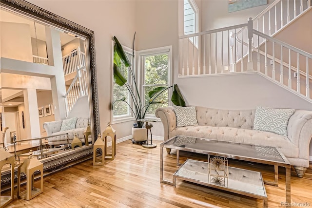 9962 Stratford Ln, Highlands Ranch, CO 80126 - living room featuring a towering ceiling, wood finished floors, and stairs