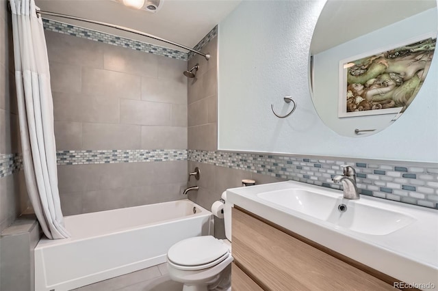 9962 Stratford Ln, Highlands Ranch, CO 80126 - bathroom with shower / tub combo with curtain, tile walls, vanity, and a wainscoted wall
