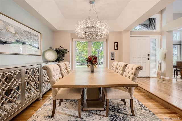 9962 Stratford Ln, Highlands Ranch, CO 80126 - dining space featuring a chandelier, wood finished floors, and a raised ceiling