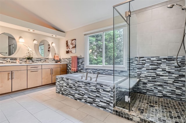 9962 Stratford Ln, Highlands Ranch, CO 80126 - full bathroom featuring vaulted ceiling, a bath, double vanity, a stall shower, and tile patterned flooring
