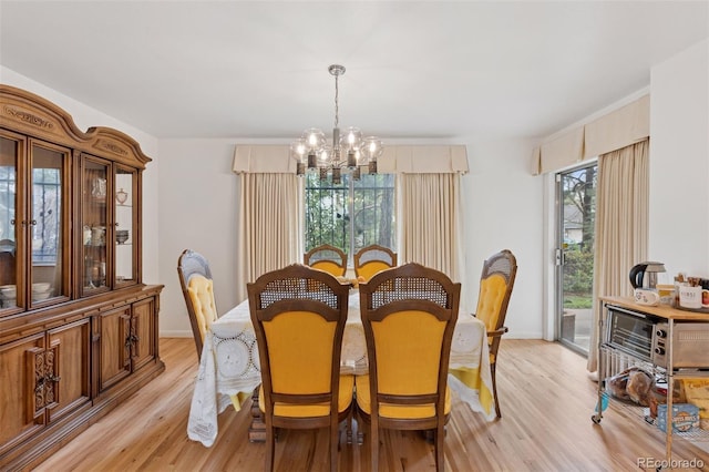 8484 E Radcliff Ave, Denver, CO 80237 - dining space with a chandelier, light wood-style floors, and baseboards
