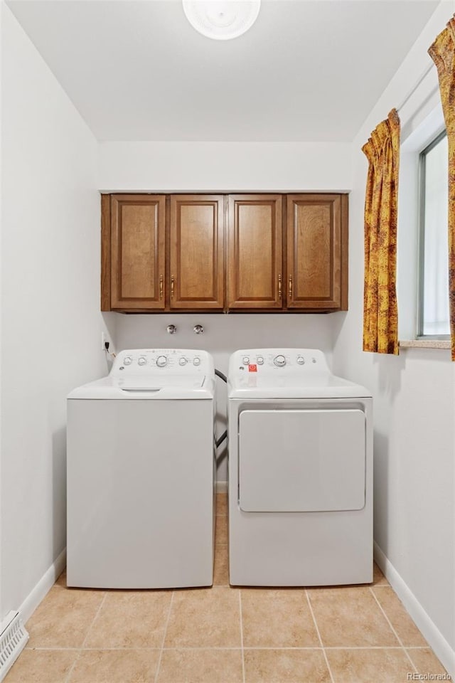 8484 E Radcliff Ave, Denver, CO 80237 - washroom with cabinet space, washer and dryer, baseboards, and light tile patterned floors