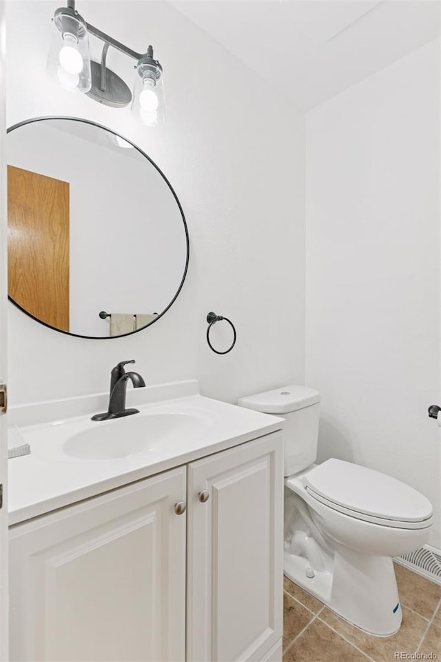 8484 E Radcliff Ave, Denver, CO 80237 - half bathroom featuring tile patterned flooring, toilet, and vanity