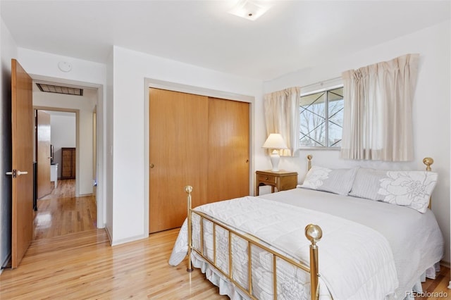 8484 E Radcliff Ave, Denver, CO 80237 - bedroom with light wood-style floors, a closet, and baseboards