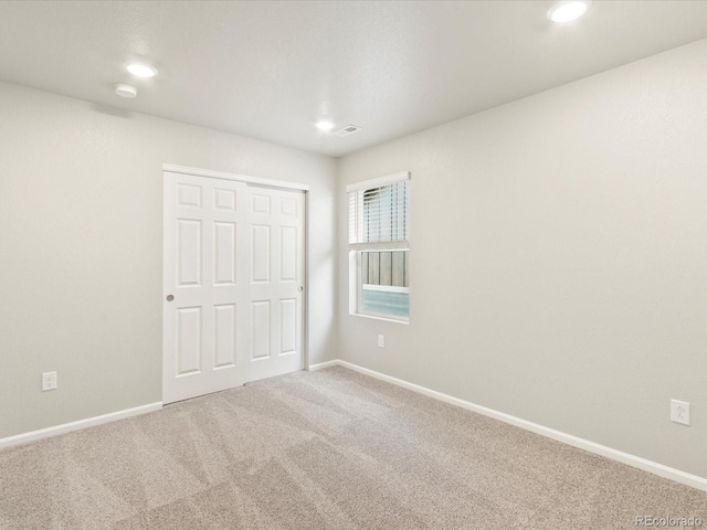 unfurnished bedroom with a closet and carpet