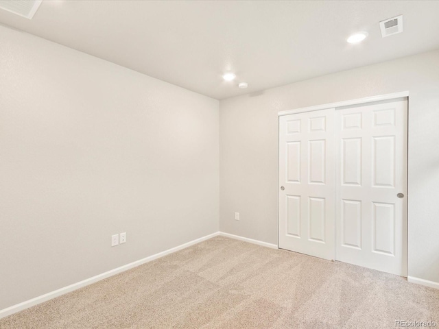 unfurnished bedroom with carpet floors and a closet