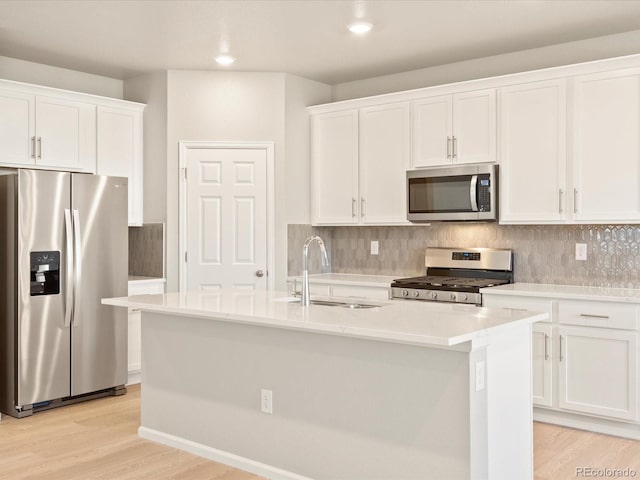 kitchen featuring sink, white cabinetry, stainless steel appliances, and light wood-type flooring